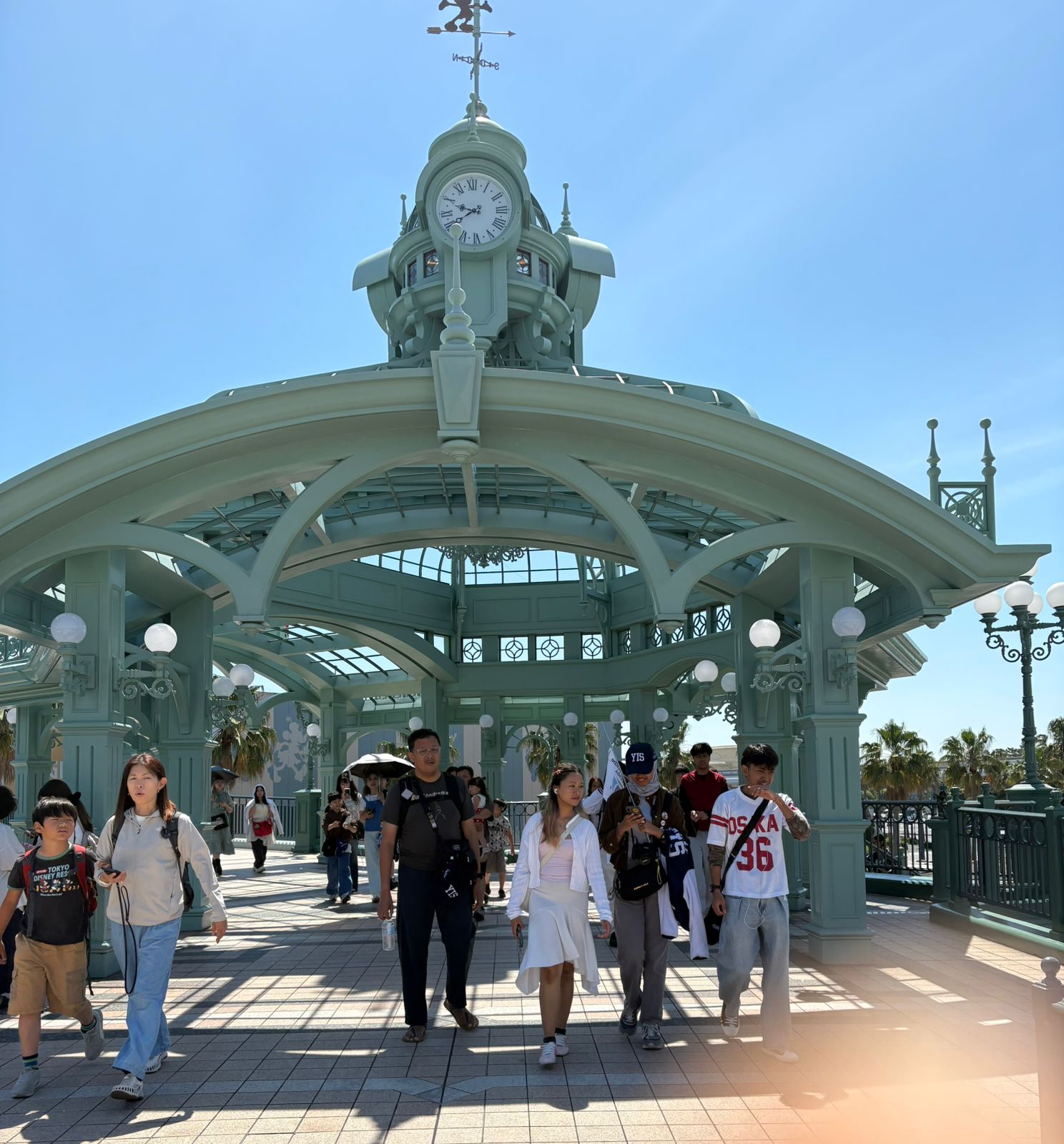 YIS travelers walking through Tokyo Disneyland in the sunshine