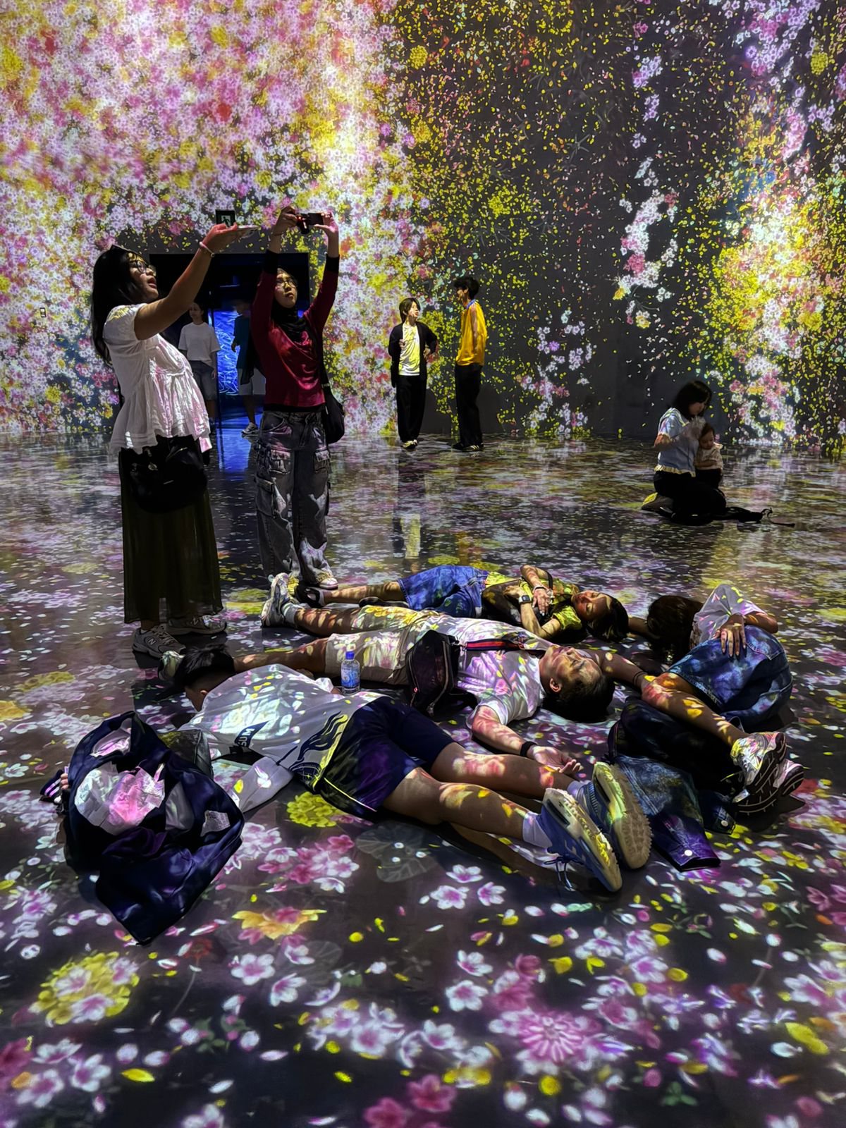 YIS students inside the flower projection rooms at teamLab Borderless