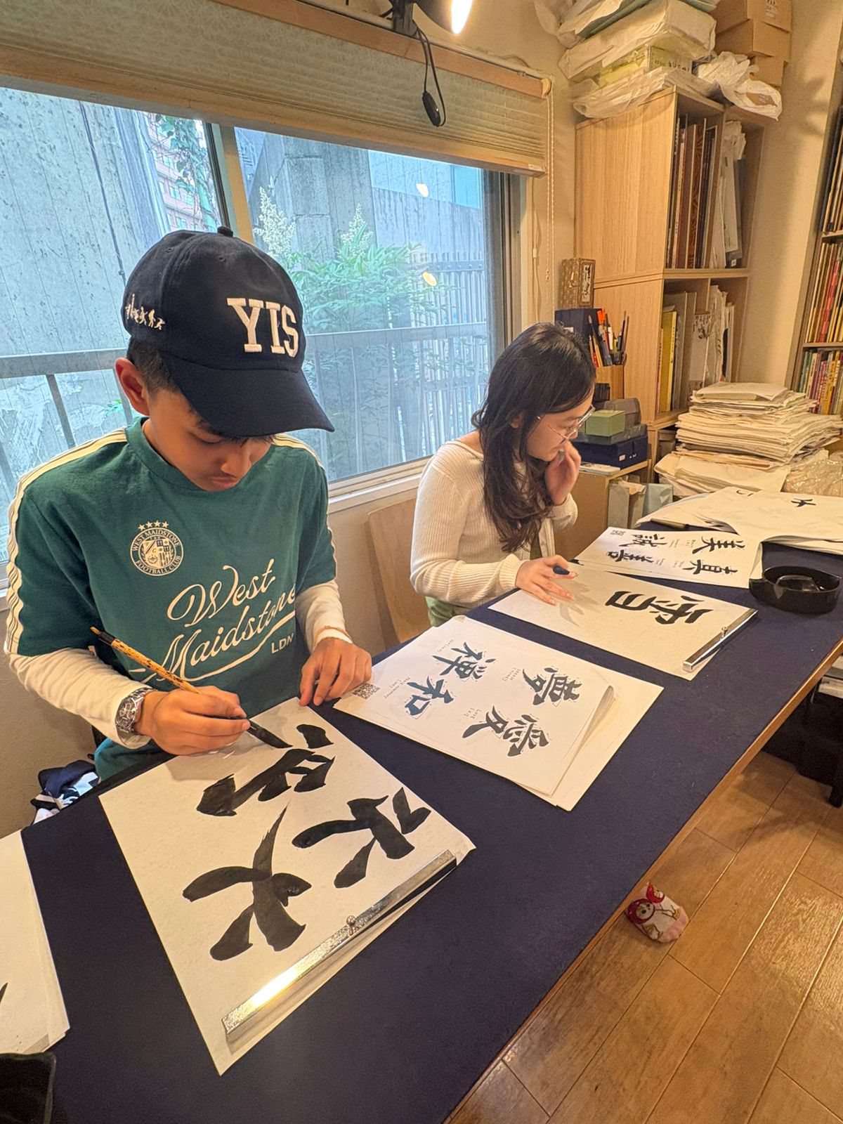 YIS students practicing calligraphy with brush and ink