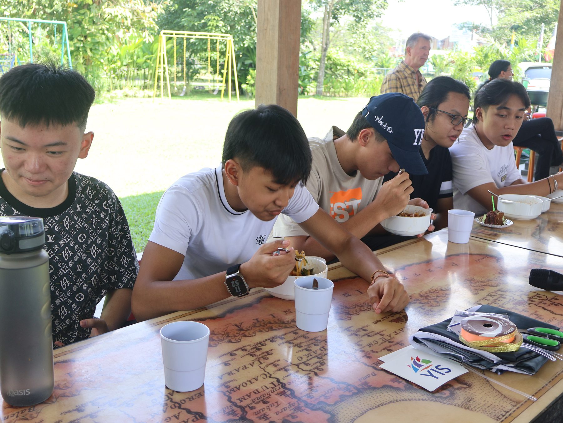 YIS students seated together before leaving for Japan