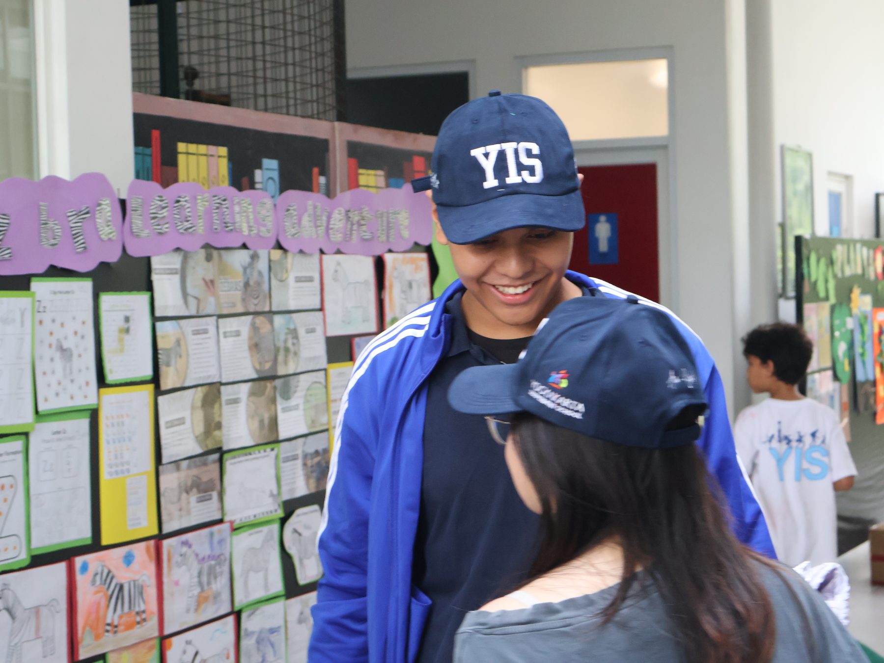 A YIS student wearing the journey cap before departure